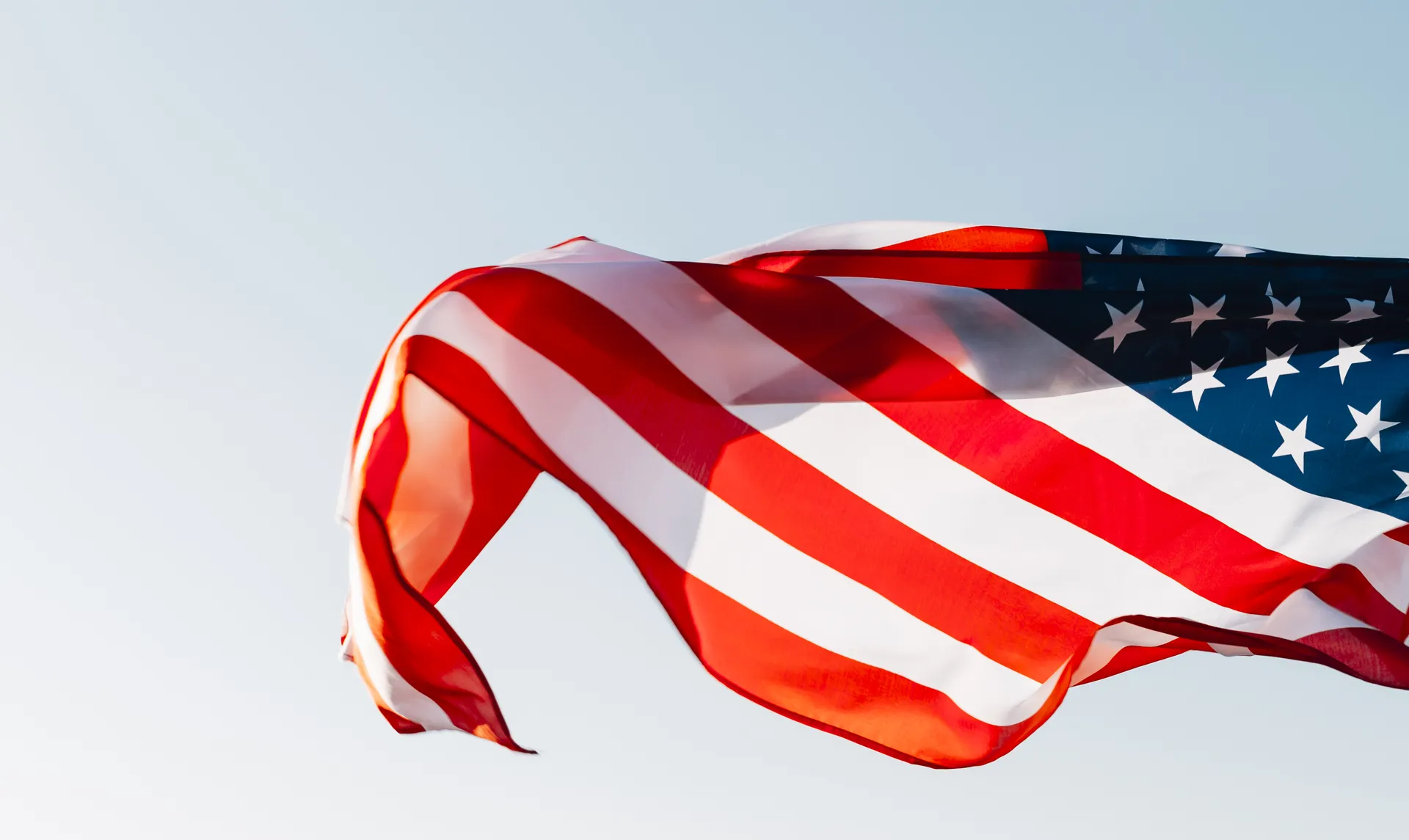 Bandeira dos Estados Unidos tremulando contra o céu